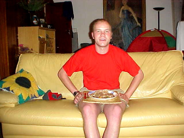 Having fine stew with rice for dinner, while watching television. Great how my BRIGHT red t-shirt disguises my sunburns, hehe.