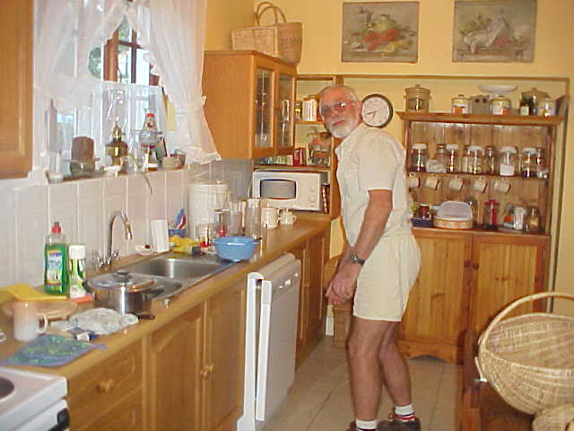 Dick Billiet prepares dinner in their full kitchen. - It is not always like this...