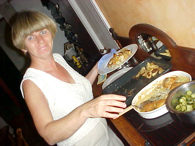 Regina piles up the plate for me, chickens in mushroom sauce are great!