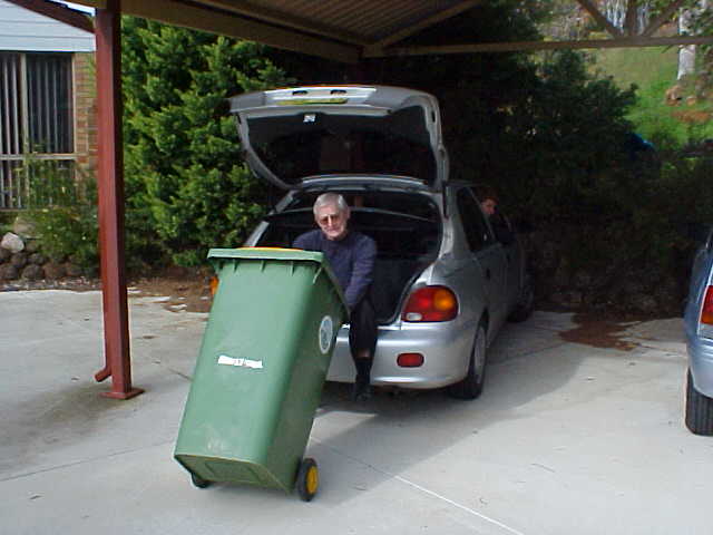 To drop their garbage container down the road, they have to drive down a steep entrance lane like this. Reg holds the container and Marijke drives the car down where Reg drops the container for pickup. Hilarious!