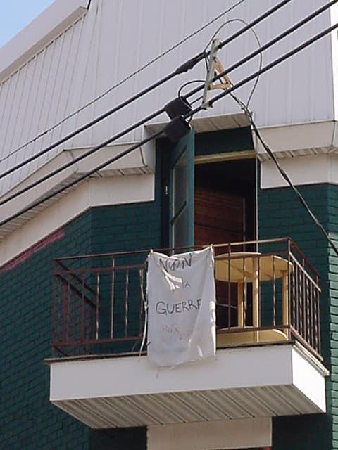 As seen in the street where Loulou and Hubert live, an anti-war flag on a balcony.