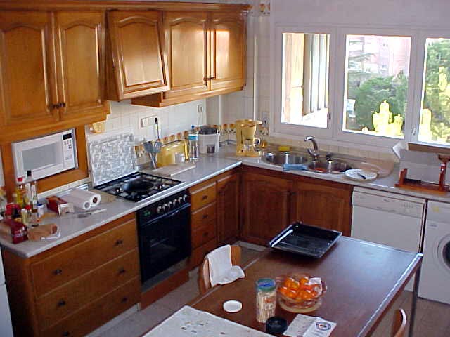The kitchen as seen from a high corner. Still you do not see how big it really is, as you are only seeing half of it....