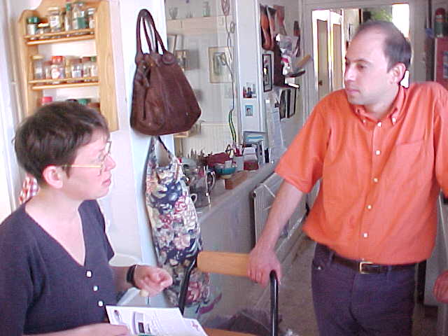 Carol and Daniele discussing dinner in the kitchen.