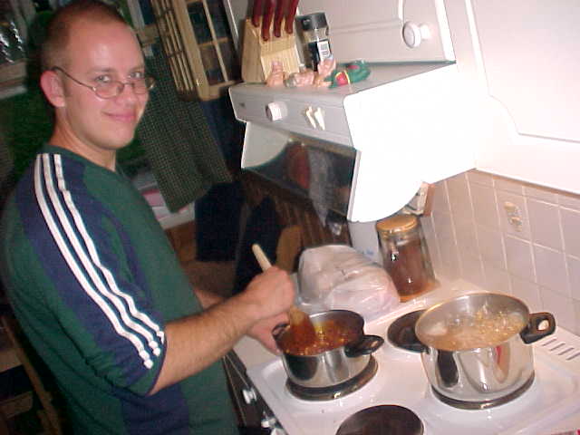 Flatmate O.J. prepares spaghetti in the kitchen, while everybody in the house was hooked on the television.